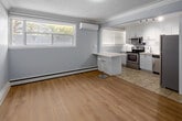 This well-appointed one-bedroom, one-bathroom unit at 233 Mohawk Rd E in Hamilton offers an efficiently designed single-floor layout that makes practical use of its compact footprint. Throughout the unit, light-toned laminate flooring and soft grey walls create a cohesive, neutral aesthetic, while white baseboards and crown moulding add a clean, polished finish. Textured ceilings are consistent across the living areas, contributing to the space's character.

The combined kitchen and living area forms the heart of the unit. The kitchen is outfitted with white cabinetry, a white countertop peninsula with bar seating, and a full suite of stainless steel appliances including a range, over-the-range microwave, dishwasher, and refrigerator. Tile flooring and a window with blinds bring practicality and natural light to this area. A wall-mounted air conditioning unit and baseboard heating ensure year-round comfort in the living space.

The bedroom is a well-proportioned, quiet retreat featuring a closet, a window with an outdoor view, baseboard heating, and the same light laminate flooring found throughout. The bathroom includes a vanity with storage, a toilet, and a tiled shower-bath combination featuring classic white subway tile accented with a decorative mosaic border, complemented by tile flooring and a window for ventilation.