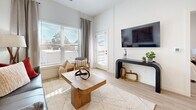 Located at 610 Jerry St in Castle Rock, CO, this thoughtfully designed one-bedroom, one-bathroom residence offers a modern aesthetic across a single, efficiently organized floor. Light wood-tone flooring flows throughout the main living areas, anchoring the clean, contemporary style.

The kitchen is a standout feature, equipped with stainless steel appliances including a range, microwave, and dishwasher. Rich dark wood cabinetry is paired with crisp white quartz countertops and a classic white subway tile backsplash. Open floating shelves add a stylish, functional touch, while a peninsula with a sink creates a natural transition into the dining area.

The living room is bright and welcoming, with large windows that invite abundant natural light and provide outdoor views. A glass door leads to the private balcony, extending the living space outdoors.

The bedroom is a comfortable retreat featuring a large window with views of the surrounding neighborhood, soft carpet flooring, and a dedicated closet. The bathroom is finished with clean white tile, a soaking tub with a rain showerhead, and a wood-accented vanity with white countertop.

Additional practical spaces include a hallway, utility room, and in-unit laundry, making this a fully equipped and functional home in a modern Castle Rock community.