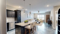 Located at 2101 Railway Ln. in Marysville, OH, this thoughtfully designed one-bedroom, one-bathroom unit offers a cohesive modern aesthetic throughout its well-proportioned single-floor layout. One of the most distinctive features is the stunning epoxy flooring that flows seamlessly through the main living areas and bedroom, displaying a swirling blue-grey marbled finish that serves as a true design centerpiece.

The open-concept kitchen and living area form the heart of the home. The kitchen is outfitted with dark espresso shaker cabinets, granite countertops with a white subway tile backsplash, stainless steel appliances, and a central island with bar seating and pendant lighting — ideal for both cooking and entertaining. The adjacent living room is bright and welcoming, featuring neutral grey walls, recessed lighting, a ceiling fan, and a window that brings in natural light.

The bedroom is a comfortable retreat with a ceiling fan, a natural light-filled window with outdoor views, and access to both a dedicated closet and the full bathroom. The bathroom continues the dark cabinetry theme, featuring a tall storage cabinet, a vessel sink vanity, and a walk-in shower, all anchored by the same striking epoxy flooring. This unit delivers a polished, contemporary living experience with high-quality finishes throughout.