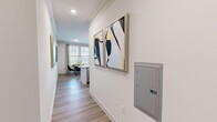This thoughtfully designed one-bedroom, one-bathroom residence on Bradford Pear Lane NW in Concord, NC offers a comfortable and modern living experience across a single well-utilized floor. The open-concept layout seamlessly connects the kitchen, dining, and living areas, creating a cohesive and functional space ideal for everyday living.

The kitchen is a standout feature, showcasing granite countertops, a large peninsula with bar seating, stainless steel appliances, white cabinetry extending to the ceiling, decorative pendant lighting, and a mosaic tile backsplash. The adjacent dining area enjoys natural light through large windows fitted with wood blinds. The living room is bright and airy, lined with multiple oversized windows that invite abundant natural light and offer open views of the surrounding landscape.

The primary bedroom is a comfortable retreat, featuring plush carpeting, built-in shelving, and direct access to the full bathroom. The bathroom is finished with granite countertops, white cabinetry, a large mirror, and a walk-in shower. A private balcony extends the living space outdoors, offering scenic views of the community grounds and surrounding Concord area. Wood-look flooring runs throughout the main living spaces, and crown molding adds a refined finishing touch.