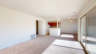 Located at 610 Towne Center Dr in Joppa, Maryland, this single-floor residence offers a functional and comfortable layout designed to maximize everyday living. The open-concept living and dining area is carpeted throughout and bathed in natural light, thanks to a large sliding glass door that opens to an outdoor view — a standout feature that creates an airy, welcoming ambiance.

The kitchen is positioned at the heart of the home, defined by warm honey-toned oak cabinetry that extends to the upper walls, offering generous storage space. A peninsula counter with a pass-through opening connects the kitchen to the living area, making it ideal for casual dining or entertaining. White appliances, including a gas range, dishwasher, and refrigerator, complement the light countertops and wood-look flooring underfoot.

The spacious bedroom is carpeted and features a window with blinds that allows for natural light and privacy. A dedicated closet provides organized storage. The hallways connect all areas efficiently, contributing to a smooth and logical flow throughout the home.

The bathroom is finished with full-height beige ceramic tile surrounding a clean white soaking tub and shower combination, paired with classic fixtures for a tidy, timeless look. This residence offers a practical, move-in ready layout in a convenient Joppa location.
