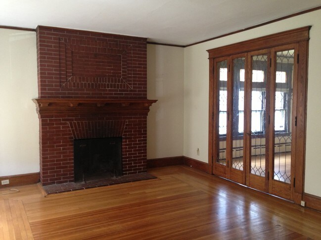 Fireplace and leaded glass doors in living rm - 640 Orange St