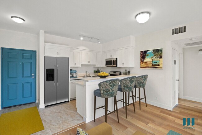Front Entrance and Open-Concept Kitchen with Countertop Bar - Overland Century