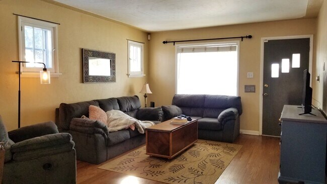 Sunny living area filled with windows, natural light & hardwood floors! - 2278 S Emerson St