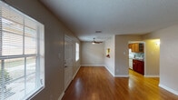 Located at 5757 Wooldridge Rd in Corpus Christi, Texas, this single-story home offers a well-organized, functional layout with consistent finishes throughout. The living area greets you upon entry with warm wood-look flooring, neutral-toned walls, and a ceiling fan that promotes airflow and comfort. Natural light filters in through windows fitted with blinds, creating a bright and welcoming atmosphere. A charming pass-through shelf connects the living space to the kitchen, adding a practical and architectural touch.

The galley-style kitchen is well-appointed with rich wood cabinetry, granite-look countertops, a tiled mosaic backsplash, a stainless steel sink, and white appliances including a refrigerator and electric range. A dedicated hallway leads to the private areas of the home, where the bedrooms feature either wood-look flooring or plush carpet, ceiling fans, and ample wall space. Each room benefits from natural light through windows.

The bathrooms are finished with wood vanities topped with granite-look counters, vessel or undermount sinks, framed mirrors, and shower-tub combinations. Textured ceilings are present throughout. Overall, the home presents a cohesive, practical design with comfortable living spaces suited for everyday life in Corpus Christi.