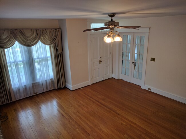 Living room, looking toward front door and french doors to dining room. NOTE: all pictures were taken before the interior was repainted - none of the old wall paper remains. - 925 North Market Street