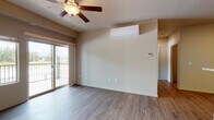 Located at 4163 West Dunkirk Avenue in Hayden, Idaho, this single-floor unit offers a thoughtfully designed layout with a clean, neutral aesthetic throughout. The main living area is anchored by wood-style plank flooring, a ceiling fan with light fixture, and a wall-mounted ductless mini-split system for efficient climate control. Sliding glass doors lead to a private balcony, providing pleasant outdoor views and abundant natural light. The kitchen is equipped with stainless steel appliances, including a refrigerator, microwave, and dishwasher, complemented by rich dark cabinetry, stone-look countertops, and a peninsula that opens to the living space. A dedicated bedroom features plush carpeting, a ceiling fan, and a large window that fills the room with natural light and scenic outdoor views. The bathroom includes a full tub and shower combination, wood-style flooring, dark vanity cabinetry with stone-look countertops, and a sink. A dedicated in-unit laundry area houses a full-size washer and dryer with overhead shelving for added storage. Additional storage is available via a closet near the entryway, rounding out this functional and comfortable Hayden residence.