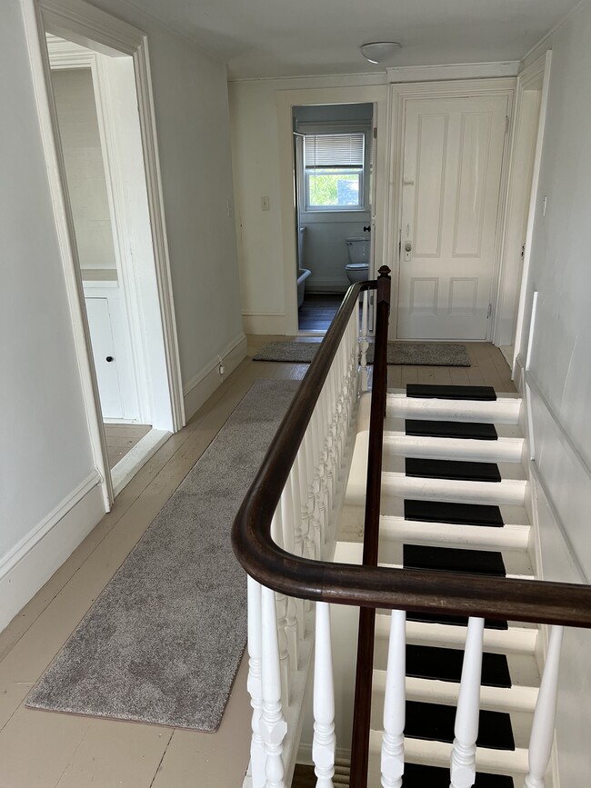 Open staircase from private front door with entry hall - 1336 County Rd