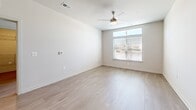 Located at 138 Rosewick Corner Pl in La Plata, MD, this thoughtfully designed 2-bedroom, 2-bathroom residence offers a clean, modern aesthetic throughout its single-floor layout. The open-concept living, dining, and kitchen area serves as the heart of the home, finished with light hardwood-style flooring that flows seamlessly from room to room. The kitchen is a standout feature, showcasing gray shaker-style cabinetry, crisp white quartz countertops, a large center island with an undermount sink, stainless steel appliances including a range, microwave, and refrigerator, and elegant pendant lighting overhead. Recessed lighting and neutral wall tones keep the space bright and inviting. The living area benefits from natural light through a wide window and is equipped with a ceiling fan for added comfort. Both bedrooms are well-proportioned, featuring light flooring, large windows with outdoor views, and ample closet space — including walk-in closets with wire shelving systems. The bathrooms are finished in a clean, contemporary style, with one featuring a tiled tub-surround with subway tiles and a gray vanity. A dedicated in-unit laundry room with full-size washer and dryer adds everyday convenience, completing this well-appointed residence.
