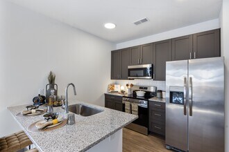 Modern Apartment Kitchen with Granite Island and Stainless Steel Appliances at Montage - Montage West Lafayette