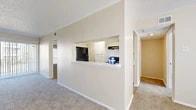 Located at 2127 Madison Dr in Arlington, TX, this single-story, 2-bedroom, 1-bathroom home offers a well-organized layout designed for comfortable everyday living. The combined kitchen and living area serves as the heart of the home, featuring a distinctive pass-through window that connects the kitchen to the living room, promoting an open and sociable atmosphere. The kitchen is outfitted with white cabinetry, light stone countertops, wood-look tile flooring, and black appliances including a refrigerator, electric range, dishwasher, and built-in range hood. The living room is carpeted and features a ceiling fan and a large window that brings in natural light. Both bedrooms are carpeted and well-lit, with generously sized windows that allow sunlight to stream in. The spacious primary bedroom includes its own closet, while a second closet provides additional storage elsewhere in the home. The full bathroom features a tub-shower combination with clean white tile surround. A dedicated laundry room includes washer and dryer hookups with wood-look tile flooring. A hallway connects the private areas of the home, completing this practical and neatly designed single-floor residence.