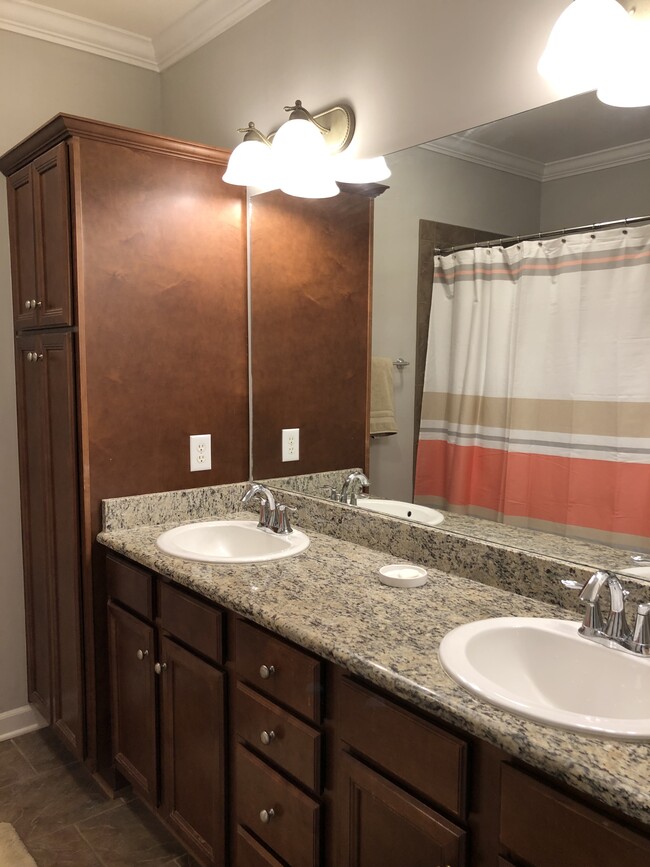 Bathroom features double sink vanity, oversized tub and rain shower - 2310 Elliott Ave