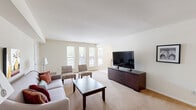 Located at 968 Kings Hwy in West Deptford, NJ, this single-floor residence offers a thoughtfully designed layout across a comfortable footprint. The expansive living area is bathed in natural light from a bank of large windows, with neutral-toned carpeting and clean white walls creating a bright, welcoming ambiance. A second living area provides additional flexibility, functioning as a secondary lounge or sitting space with its own distinct character.

The dining area features tile flooring and generous natural light from adjacent windows, offering an inviting space for everyday meals. A dedicated kitchen sits nearby, completing the home's functional core.

The spacious primary bedroom is a true retreat, accommodating a full furniture arrangement with room to spare. It features carpeted flooring, ample closet space, and windows that allow natural light to filter in comfortably. A dedicated closet adds to the bedroom's practicality.

The full bathroom is finished with classic yellow subway tile wainscoting, mosaic tile flooring, a vanity with wood cabinetry, and a tub-shower combination. The in-unit laundry area adds everyday convenience. Throughout the residence, the consistent neutral palette and carpet flooring lend a cohesive, move-in-ready feel.
