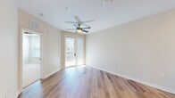Located at 500 Verdant Way in Charleston, SC, this thoughtfully designed one-bedroom, one-bathroom residence offers a bright and modern living experience across a single floor. The open-concept kitchen and living area serves as the heart of the home, featuring warm hardwood-style flooring, a ceiling fan, and a glass door that invites natural light and outdoor views. The kitchen is well-equipped with crisp white cabinetry, a central island with a light quartz countertop, stainless steel appliances, a textured tile backsplash, and a stylish pendant light fixture with a wood-and-metal frame. The spacious bedroom is finished with plush carpet, a ceiling fan, and a window with exterior views, offering a comfortable retreat. Three closets—including a generously sized walk-in with wire shelving—provide abundant storage. The bathroom showcases a dual-sink vanity with white cabinetry, black hardware accents, a well-lit mirror, and matching hardwood-style flooring. Additional conveniences include a dedicated laundry area and a pantry. Neutral tones, clean lines, and consistent finishes throughout give the residence a cohesive, contemporary feel.