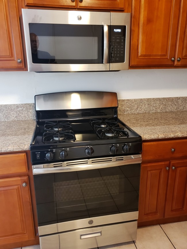 stainless steel range and microwave - 3450 Monroe St
