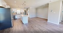 This contemporary 1360 square foot apartment offers a spacious and well-designed living space. The single-floor layout comprises three bedrooms and three full bathrooms, providing ample privacy for residents. The heart of the home is an open-concept living area that seamlessly integrates the kitchen and living room, perfect for entertaining or family gatherings.

The kitchen is a standout feature, boasting pristine white cabinetry, sleek stainless steel appliances, and quartz countertops. Pendant lighting adds a touch of elegance, while the kitchen island provides additional workspace and casual seating.

Each bedroom is generously sized, with the primary bedroom measuring 170 square feet. The rooms feature neutral color schemes and wood-look flooring, creating a blank canvas for personal styling. The bathrooms are modern and functional, with one showcasing a tiled tub-shower combination.

Storage is plentiful throughout the apartment, with a walk-in closet offering customizable shelving. The dedicated laundry room comes equipped with full-sized washer and dryer units, adding convenience to daily life.

Located at 12500 Barker Cypress Rd in Cypress, TX, this apartment is part of a well-maintained complex with ample parking and green spaces. The property's exterior features brick and siding construction typical of modern apartment developments in the area.