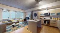 Located at 120 Westlake Avenue in Seattle's South Lake Union neighborhood, this single-floor unit showcases a thoughtfully designed modern interior with industrial-inspired architectural details. Exposed concrete ceilings and visible ductwork run throughout, lending an urban loft aesthetic that is balanced by warm bamboo hardwood flooring underfoot.

The open-concept living and kitchen area serves as the heart of the space. The living room benefits from an expansive wall of large windows that flood the room with natural light and offer outdoor views. A bold geometric-patterned area rug anchors the seating area, which is complemented by a concrete accent column and a built-in media unit.

The kitchen is well-appointed with light wood cabinetry featuring frosted glass upper panels, stainless steel appliances including a gas range and French door refrigerator, a deep sink, and a central island with bar seating — ideal for casual dining or entertaining.

The bedroom is a serene retreat, highlighted by a striking chevron-patterned wood headboard and continued bamboo flooring, with a spacious sliding-door closet providing ample storage. The bathroom features tile flooring, a soaking tub with shower, a wood-front vanity, and clean neutral finishes.

A hallway connects the rooms with art-adorned walls and warm accent colors, completing this well-curated urban residence.