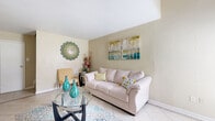 Located in Houston, TX, this two-story home offers a well-organized layout across two floors. The main level features light-filled common areas finished with neutral-toned tile flooring throughout. The living room is a welcoming space anchored by a fireplace and windows that invite natural light, complemented by warm, neutral wall tones. Adjacent to the living room, a dedicated dining area offers a bright window view, creating an ideal setting for everyday meals. The kitchen and a convenient laundry area round out the functionality of the main floor, connected by a hallway and staircase. Upstairs, the generously sized primary bedroom is carpeted for comfort and features a ceiling fan, multiple windows that bring in natural light, and two closets offering ample storage. The bathroom is finished with large-format marble-look tile on both the floors and tub surround, paired with a granite-topped vanity for an elevated feel. Two staircases connect the floors, contributing to the home's efficient flow. The overall aesthetic throughout is clean, bright, and move-in ready, with a consistent neutral palette that creates a calm and cohesive ambiance.