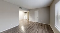 Located at 2050 Old Clinton Rd in Macon, Georgia, this single-story 2-bedroom, 1-bathroom residence offers a well-organized layout designed for comfortable everyday living. The living room features durable wood-look vinyl flooring, neutral gray walls, and a large window that allows natural light to fill the space, creating a bright and open feel. It flows seamlessly into the kitchen and laundry area, enhancing the sense of connectedness throughout the home. The galley-style kitchen is equipped with dark upper cabinetry contrasting white lower cabinets, a double-basin stainless steel sink, a dishwasher, electric range, refrigerator, and a skylight-style ceiling fixture that keeps the space well-lit. An in-unit washer and dryer area is conveniently integrated adjacent to the kitchen. Both bedrooms are carpeted and include ceiling fans with light fixtures and windows with blinds for natural light and ventilation. The spacious primary bedroom features direct access to the bathroom and a closet. The shared bathroom includes a tiled shower-tub combination with chrome fixtures and wood-look flooring. A dedicated closet provides additional storage. Neutral tones and practical finishes create a cohesive, functional living environment throughout.