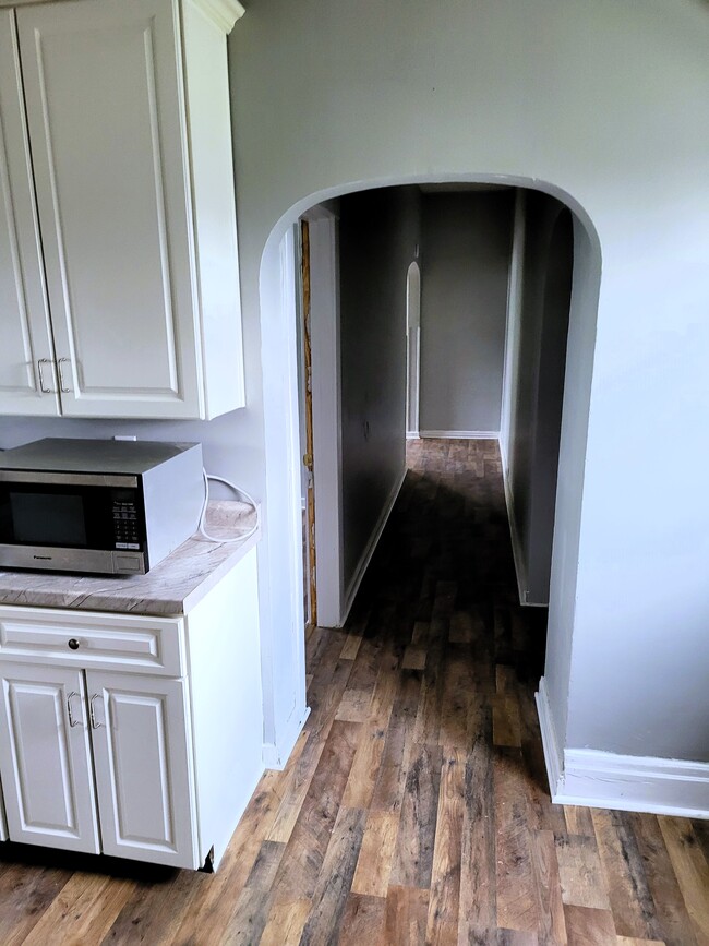 Kitchen looking to spare bed (left), downstairs (right), living room (straight) - 414 Erie Ave