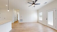 Located at 195 Eddings Rd in Franklin, Kentucky, this 2-bedroom, 2-bathroom unit offers a clean, modern interior with a cohesive design throughout. Light wood-style flooring runs continuously across all rooms, contributing to a bright and airy feel that is reinforced by neutral white walls and abundant natural light from well-placed windows with blinds.

The open kitchen and living area serves as the heart of the unit. The kitchen is outfitted with crisp white shaker-style cabinetry, granite-look countertops, a stainless steel appliance suite including a range, over-the-range microwave, and refrigerator, and a peninsula with pendant lighting — ideal for both cooking and casual dining. Crown molding and recessed lighting add a polished touch to this space.

The living area features a full-light exterior door, offering outdoor access and additional natural light, along with a ceiling fan for comfort. Both bedrooms are generously proportioned, each equipped with ceiling fans and large windows. The primary bedroom includes direct access to a dedicated closet and an en-suite bathroom. Both bathrooms mirror the home's clean aesthetic with white vanities, granite-style countertops, and wood-look flooring. One bathroom includes a soaking tub, while the other features a stand-alone layout. The overall ambiance is fresh, functional, and move-in ready.