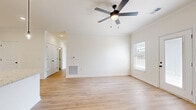 Located at 195 Eddings Rd in Franklin, Kentucky, this 2-bedroom, 2-bathroom unit offers a clean, modern interior with a cohesive design throughout. Light wood-style flooring runs continuously across all rooms, contributing to a bright and airy feel that is reinforced by neutral white walls and abundant natural light from well-placed windows with blinds.

The open kitchen and living area serves as the heart of the unit. The kitchen is outfitted with crisp white shaker-style cabinetry, granite-look countertops, a stainless steel appliance suite including a range, over-the-range microwave, and refrigerator, and a peninsula with pendant lighting — ideal for both cooking and casual dining. Crown molding and recessed lighting add a polished touch to this space.

The living area features a full-light exterior door, offering outdoor access and additional natural light, along with a ceiling fan for comfort. Both bedrooms are generously proportioned, each equipped with ceiling fans and large windows. The primary bedroom includes direct access to a dedicated closet and an en-suite bathroom. Both bathrooms mirror the home's clean aesthetic with white vanities, granite-style countertops, and wood-look flooring. One bathroom includes a soaking tub, while the other features a stand-alone layout. The overall ambiance is fresh, functional, and move-in ready.