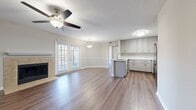 This renovated 620 square foot apartment in Nashville, TN offers a blend of compact living and modern amenities. The single-story layout includes one bedroom, measuring 170 square feet, and two full bathrooms. The heart of the home is an open-concept living area, featuring a cozy fireplace with a tiled surround and a convenient mantel shelf. Large windows and French doors flood the space with natural light and provide access to an outdoor area.

The kitchen has been fully updated with light-colored cabinetry, marble-like countertops, and stainless steel appliances, including a built-in microwave. A central island with a sink adds functionality and defines the kitchen space within the open floor plan.

Throughout the apartment, warm wood-look flooring creates a cohesive and inviting atmosphere. Ceiling fans with integrated lighting fixtures enhance comfort and illuminate the rooms. The bathroom showcases a clean, modern design with a white vanity, large mirror, and a combination tub-shower unit.

The bedroom is spacious and bright, with ample room for a large bed and additional furniture. A walk-in closet provides generous storage space. The apartment's neutral color palette and contemporary finishes make it an ideal canvas for personalization, suitable for a variety of lifestyles in the heart of Nashville.
