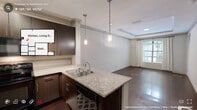 Located at 500 S Lasalle St in Durham, NC, this thoughtfully designed 2-bedroom, 2-bathroom residence offers a cohesive blend of modern finishes and comfortable living across a single floor. The open-concept kitchen and living area serves as the heart of the home, where rich dark wood cabinetry, granite countertops, a stone tile backsplash, and black appliances create a striking culinary space. A peninsula with bar seating and pendant lighting provides a seamless transition into the living area. The living room is highlighted by an elegant tray ceiling with crown molding, dark hardwood floors, and large arched windows that flood the space with natural light and offer outdoor views. A private exterior door adds additional convenience. Both bedrooms feature plush carpet, ceiling fans, and windows with outdoor greenery views. The primary bedroom provides a comfortable and well-proportioned retreat. Each bathroom is finished with tile flooring, dark wood vanities, granite countertops, and well-lit mirrors. One bathroom includes a tub/shower combo with classic white subway tile surround. A carpeted hallway connects the private quarters, with a closet and utility room completing the layout. The overall ambiance is warm, polished, and move-in ready.