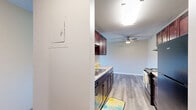 Located at 2150 Wilson Ave in Saint Paul, MN, this one-bedroom, one-bathroom unit offers a well-organized, single-floor layout designed for comfortable everyday living. The galley-style kitchen is a standout feature, equipped with rich dark-wood cabinetry, granite-style countertops, a stainless steel sink, and black appliances including an electric range and refrigerator. Durable hardwood-style flooring runs throughout the kitchen, which flows directly into the combined living area. The living room is generously sized, featuring plush carpet, a ceiling fan, and a large sliding glass door that fills the space with natural light and opens onto a private balcony with outdoor views. The bedroom offers comfortable proportions with carpet flooring, a wall-mounted air conditioning unit, baseboard heating, and a wide sliding-door closet providing ample storage. Additional closets throughout the unit offer further organizational flexibility. The bathroom is neatly appointed with dark wood vanity cabinetry, a granite-style countertop, a tub-shower combo, and hardwood-style flooring. Baseboard heating and individual air conditioning units are present in multiple rooms, ensuring year-round comfort. Textured ceilings are consistent throughout the unit, giving it a classic residential character.
