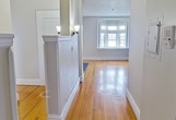 This 710 square foot apartment, located at 17 State St, Unit 6C in Troy, NY, offers a blend of historic charm and modern updates. The space features two bedrooms, including a primary bedroom of 180 square feet, and one bathroom. Throughout the apartment, beautiful hardwood floors add warmth and character.

The living room is a highlight, boasting a bay window that floods the space with natural light and a decorative fireplace that serves as a focal point. High ceilings contribute to an open, airy feel. The kitchen has been updated with modern white cabinetry, dark countertops, and black appliances, including a gas range and refrigerator.

The bathroom has been renovated with large, white tile and a shower/tub combination. Both bedrooms feature hardwood floors and ample natural light. The apartment retains some of its original character with details like radiators for heating and traditional wooden doors.

A hallway connects the various rooms, enhancing the flow of the space. The apartment's layout makes efficient use of its 710 square feet, creating a cozy yet functional living environment. Its location in Troy, NY, puts residents in proximity to local amenities and attractions.