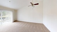 Located at 30823 18th Ave S in Federal Way, WA, this one-bedroom, one-bathroom residence offers a thoughtfully utilized single-floor layout with a clean, neutral aesthetic throughout. The living room is a standout space, featuring vaulted ceilings that lend a sense of openness and volume, plush wall-to-wall carpeting, and a ceiling fan. Sliding glass doors fitted with vertical blinds open directly onto a private balcony, bringing in natural light and views of the surrounding neighborhood. The kitchen is well-appointed with crisp white shaker-style cabinetry, light stone-look countertops, stainless steel appliances including a refrigerator and range with overhead ventilation, and recessed lighting — offering a functional and modern cooking space. The bedroom is a comfortable size, carpeted like the living areas, and includes a large window with blinds that allows natural light in while providing privacy. A baseboard heating system runs along the wall. The full bathroom features a combined tub and shower with clean white surrounds. Four closets are distributed throughout the unit, providing generous storage. A hallway connects the main areas efficiently, completing this well-organized and move-in ready residence.