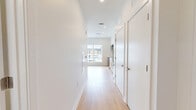 Located at 6320 Shakespeare St in Pittsburgh's East Liberty neighborhood, this one-bedroom, one-bathroom unit offers a thoughtfully designed layout with modern finishes throughout. The open-plan living and kitchen area is anchored by large windows that flood the space with natural light and provide views of the surrounding neighborhood. Light-toned hardwood flooring extends across the main living area, creating a warm, cohesive feel.

The kitchen is well-appointed with a two-tone design featuring white upper cabinetry and warm wood-finish lower cabinets, complemented by a white subway tile backsplash and gold-toned hardware. Stainless steel appliances — including a range, microwave, dishwasher, and refrigerator — complete the functional and stylish cooking space.

The bedroom offers a clean, minimalist environment with the same light hardwood flooring, bright white walls, and ample wall space. The bathroom is finished with large-format gray floor tiles, white subway tile surrounding the tub/shower combo, and a wood-accented vanity with modern fixtures. Recessed lighting throughout the unit contributes to a bright, contemporary ambiance. This well-designed unit is an excellent option for those seeking modern urban living in Pittsburgh.