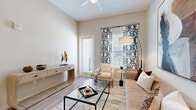 Located at 5905 Caravan Ct in Orlando, Florida, this thoughtfully designed 2-bedroom, 2-bathroom residence offers a comfortable and modern single-floor layout. Light-toned luxury vinyl plank flooring flows throughout, tying together a cohesive and airy aesthetic. The open-concept kitchen and living area forms the heart of the home, with the kitchen showcasing white shaker cabinetry, quartz countertops, a large island with bar seating, pendant lighting, and stainless steel GE appliances including a French door refrigerator, range, and microwave. The living room benefits from tall ceilings, a ceiling fan, and access to natural light through large windows and a glass door, creating a bright and welcoming atmosphere. The generously sized primary bedroom offers ample space and direct access to a dedicated closet and bathroom. The second bedroom also features large windows with outdoor views, filling the room with natural light. Both bathrooms are finished with white vanity cabinetry, quartz countertops, and tub-shower combinations. Two closets provide organized storage throughout the residence, completing this well-appointed Orlando home.