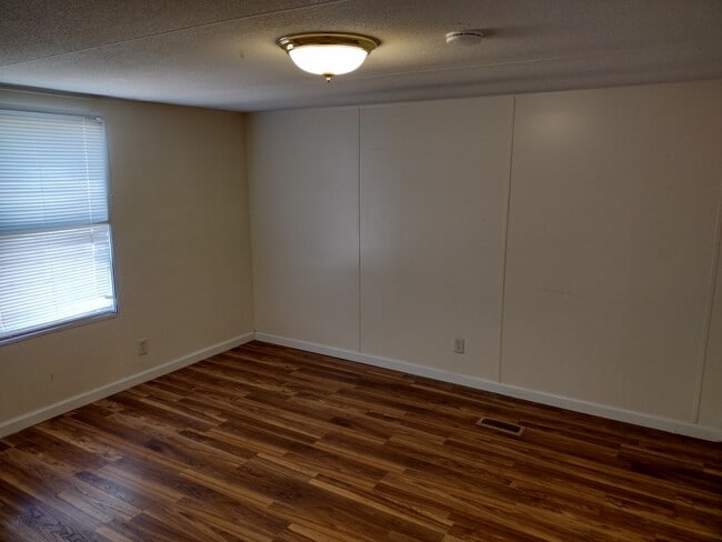 Master bedroom located at the rear of the home, his and hers closet. - 716 N Houston Lake Blvd