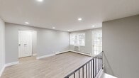 Located at 1 Harned Ave in Somerdale, NJ, this thoughtfully updated one-bedroom, one-bathroom unit offers a clean, modern aesthetic throughout its efficiently designed single-floor layout. Light-toned luxury vinyl plank flooring runs seamlessly through the living areas, kitchen, hallway, and bedroom, creating a cohesive and easy-to-maintain interior.

The kitchen is a standout feature, outfitted with gray shaker-style cabinetry, white quartz countertops, a subway tile backsplash, and a full suite of stainless steel appliances including a gas range, over-the-range microwave, and refrigerator. A window brings in natural light and overlooks greenery outside. Conveniently tucked within the hallway area is a stacked washer and dryer unit, adding in-unit laundry to the home's practical appeal.

The bedroom offers a comfortable and quiet retreat, featuring a large window with views of mature trees, a baseboard heating unit, and two closets with panel doors. The bathroom is finished with large-format tile flooring and a tub/shower combination clad in floor-to-ceiling gray tile, complemented by brushed nickel fixtures. Neutral gray walls, white trim, and flush-mount lighting tie the entire space together in a fresh, contemporary style.