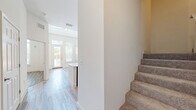 Located at 1659 2nd St in Sarasota, FL, this thoughtfully designed two-story residence offers four bedrooms and six bathrooms across two well-proportioned floors. The ground floor features an open-concept living area with light wood-look flooring and soaring ceilings that create an airy, expansive feel. The modern kitchen is a standout, showcasing a quartz waterfall island with an undermount sink, a contrasting combination of white upper and dark wood-grain lower cabinetry, a tile backsplash, and a full suite of stainless steel appliances. A dedicated laundry room with a full-size washer and dryer adds everyday convenience. The upper floor hosts the bedrooms, each finished with plush carpet and bright windows offering tree-lined views. The primary bedroom is generously sized and benefits from ample natural light. The six bathrooms are elegantly appointed with large-format tile flooring, marble-look quartz countertops, and clean white vanities, with some featuring walk-in showers. Four closets and two hallways provide excellent storage and circulation throughout. The overall aesthetic is clean, contemporary, and bright—ideal for modern living in the heart of Sarasota.