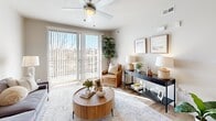 This thoughtfully designed one-bedroom, one-bathroom residence in West Valley City, Utah, offers a practical and stylish single-floor layout. The open-concept kitchen is a standout feature, boasting rich dark wood cabinetry, a mosaic tile backsplash, granite countertops, stainless steel appliances, and a peninsula with bar seating illuminated by pendant lighting — ideal for both cooking and casual dining. The kitchen flows seamlessly into the living room, which is bright and airy thanks to large sliding glass doors that invite natural light and provide outdoor access. Light hardwood-style flooring runs throughout the main living areas, complementing the neutral color palette. The bedroom offers plush carpeting, a ceiling fan, and a generously sized window that fills the room with natural light. A dedicated closet provides ample storage, and the in-unit laundry room features a full-size washer and dryer. The bathroom includes a tub-shower combination, wood-toned cabinetry, and coordinating hardwood-style flooring. A dedicated entrance completes the layout. Every detail of this residence reflects a clean, modern aesthetic designed for comfortable everyday living.