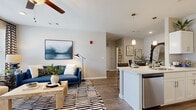 Located in White House, TN, this well-appointed one-bedroom, one-bathroom residence offers a thoughtfully designed single-floor layout that maximizes every square foot. The open-concept living, dining, and kitchen area creates a seamless flow throughout the main living space. The kitchen features white cabinetry, stainless steel appliances including a refrigerator, microwave, and range, and a peninsula with pendant lighting and bar seating — ideal for casual dining or entertaining. A separate dining area provides additional space for a full dining set. The living room is bright and inviting, benefiting from large windows with outdoor views and access to a private balcony, complemented by a ceiling fan and wood-look flooring that runs throughout the home. The bedroom is a comfortable retreat, offering a walk-in closet and a window that fills the room with natural light. The full bathroom includes a white vanity with ample drawer storage, a large mirror, and a tub/shower combination. A dedicated in-unit laundry room with overhead cabinetry adds everyday convenience. Neutral-toned walls and consistent flooring tie the entire space together with a clean, modern aesthetic.