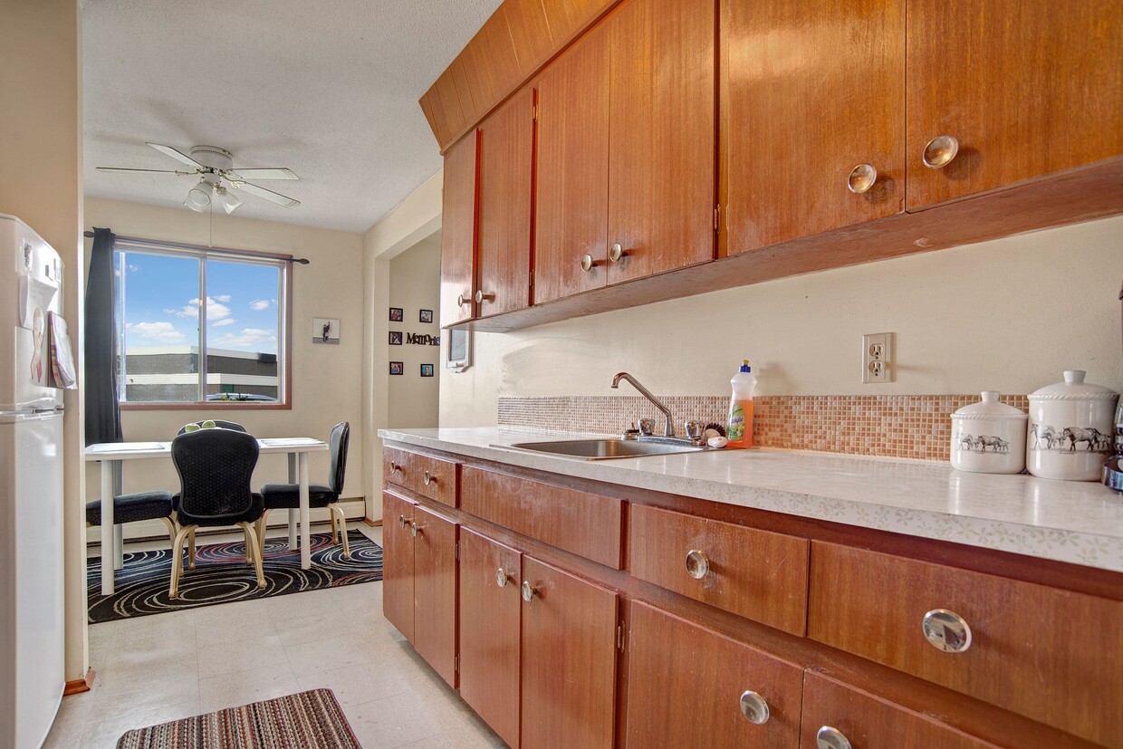 A kitchen with sleek white appliances and wood cabinetry - Alderview