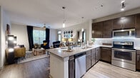 Located at 645 Old Hickory Boulevard in Nashville, TN, this well-appointed 2-bedroom, 3-bathroom residence offers a thoughtfully designed single-floor layout. The open-concept kitchen flows seamlessly into the living area, anchored by a central island with granite countertops, a stainless steel dishwasher, and pendant lighting overhead. Rich dark-wood cabinetry lines the kitchen walls alongside a full suite of stainless steel appliances, including a refrigerator, range, and microwave, all complemented by a classic subway tile backsplash and wood-style flooring. The living room is bright and welcoming, featuring large windows that invite natural light and a ceiling fan for comfort. Both bedrooms offer plush carpeting, natural light through well-sized windows, and generous closet space, including walk-in closets with wire shelving systems. The primary bedroom is a comfortable retreat, while the additional bedroom provides equal charm. Three full bathrooms are finished with granite-topped vanities, dark cabinetry, and tub-shower combinations with white subway tile surrounds. Two dedicated closets provide ample storage throughout the home, completing this functional and stylish Nashville residence.