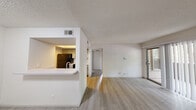 Located at 3209 S IH-35 Service Rd in Austin, TX, this one-bedroom, one-bathroom unit offers a thoughtfully organized single-floor layout that makes efficient use of its space. The living area features light-toned wood-look flooring, neutral white walls, and a textured ceiling. A sliding glass door fills the room with natural light and opens to a private outdoor patio, creating a seamless indoor-outdoor connection. The kitchen is designed in a galley style, featuring gray cabinetry, white countertops, and black appliances including a refrigerator, electric range, and over-the-range microwave. A pass-through window with a breakfast bar connects the kitchen to the living area, enhancing the open feel of the space. A hallway leads from the main living area to the bedroom and bathroom. The bedroom is carpeted for comfort and includes a ceiling fan, natural light from multiple windows with blinds, and a dedicated closet for storage. The bathroom is clean and functional, featuring a full tub-shower combination with white tile surround and chrome fixtures. Throughout the unit, the consistent use of neutral tones and practical finishes contributes to a bright, cohesive, and move-in-ready atmosphere.