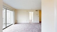 This 500 square foot apartment in Winter Park, Florida, offers a well-designed living space on a single floor. The property features one bedroom spanning 140 square feet, providing ample space for rest and relaxation. The apartment's layout includes a single bathroom, ensuring convenience for occupants.

The kitchen is a highlight, boasting white cabinetry, granite countertops, and a stylish mosaic tile backsplash. Modern appliances, including a refrigerator and stove, are provided. The kitchen's design incorporates a mix of wood-look flooring and carpeting, seamlessly transitioning to the living areas.

The living and bedroom spaces feature plush carpeting, creating a cozy atmosphere. Large windows in these areas allow natural light to flood the rooms, enhancing the sense of spaciousness. The bedroom includes built-in closet space with louvered doors, maximizing storage efficiency.

The bathroom, while compact, is thoughtfully designed with a vanity featuring a granite countertop, a large mirror, and wood flooring that adds warmth to the space. Throughout the apartment, neutral wall colors provide a blank canvas for personal decorating styles.

Ceiling fans and recessed lighting fixtures contribute to the overall comfort and ambiance of this efficiently designed living space, making it an ideal home for individuals or couples seeking a cozy, low-maintenance residence in Winter Park.