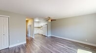 Located at 2800 Gentrytown Dr in Antioch, CA, this well-appointed one-bedroom, one-bathroom unit offers a thoughtfully designed single-floor layout. The open living area features durable hardwood-style flooring and a ceiling fan with light fixture, creating a bright and comfortable atmosphere. Large windows allow natural light to pour in, enhancing the airy feel of the space. The kitchen is well-equipped with crisp white shaker-style cabinetry, light quartz countertops, a stainless steel sink, a gas range, and a dishwasher — all finished with modern brushed nickel hardware. The bedroom is carpeted for comfort, includes its own ceiling fan, and features a sliding glass door providing additional light and access. A dedicated closet provides convenient storage. The bathroom is clean and modern, outfitted with a white vanity, a tub-shower combination, and brushed nickel fixtures. Neutral gray tones throughout the walls complement the light flooring, giving the unit a cohesive, contemporary aesthetic. The layout makes efficient use of the available space, offering a practical and comfortable living environment in the Antioch community.