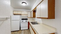 Located at 3300 E Deerfield Rd in Mount Pleasant, Michigan, this single-floor unit offers three bedrooms and one bathroom within a well-organized layout. The living area is generously sized, featuring neutral carpet flooring, baseboard heating, a textured ceiling, and a sliding glass door that opens to a private balcony with outdoor views, allowing natural light to fill the space.

The kitchen is efficiently designed with ample white cabinetry accented by wood trim, a double-basin stainless steel sink, a full-size refrigerator, and an electric range, all set on wood-look flooring beneath a textured ceiling.

Each of the three bedrooms is carpeted and includes a window fitted with blinds for natural light and privacy, along with baseboard heating. The primary bedroom is a comfortable size and features both a closet and access to a dedicated walk-in closet with dual shelving rails and carpeted flooring, offering generous storage.

The bathroom is clean and bright, featuring wood-look tile flooring, a single-sink vanity with storage drawers, a large mirror, and a full tub-shower combination. A hallway and additional closet space complete this practical and straightforward floor plan.