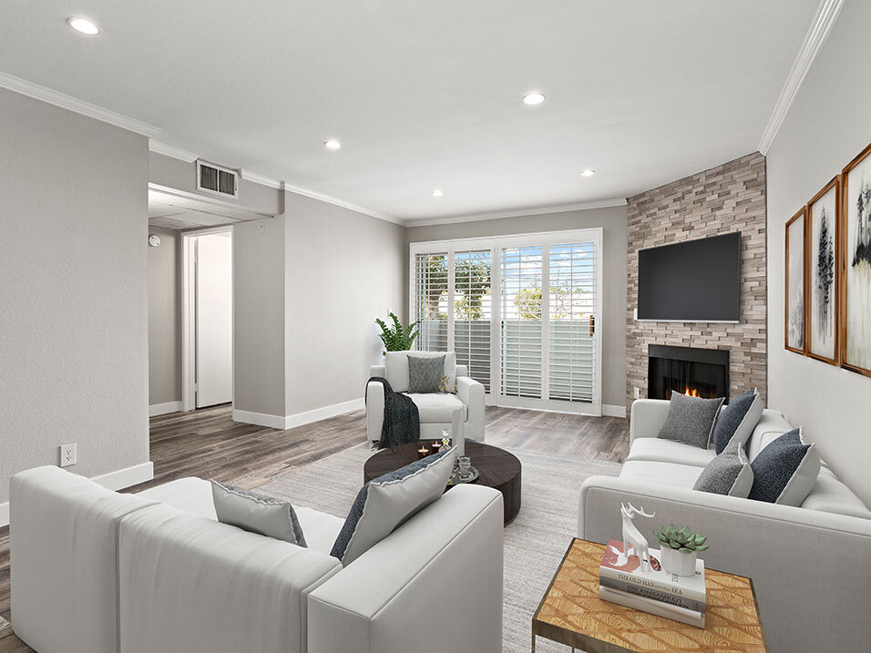 Hardwood floored living room with stone accented fireplace. - Magnolia Terrace