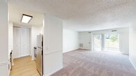 Located at 3554 Weymouth St in Durham, NC, this single-story, one-bedroom, one-bathroom home offers a well-organized layout across a comfortable footprint. The space flows from a welcoming entrance through a hallway connecting all principal rooms.

The living room is the heart of the home, featuring warm carpet flooring, a textured ceiling, and large sliding glass doors that flood the area with natural light and provide direct outdoor access. A built-in desk or countertop nook adds a practical touch to the living space.

The kitchen is efficiently designed with white shaker-style cabinetry accented by matte black hardware, a smooth-top electric range, and a stainless steel refrigerator. Wood-look flooring grounds the kitchen's clean, modern aesthetic.

The bedroom is a spacious retreat with plush carpet flooring, a window that brings in natural light, and an impressive wall of bifold closet doors offering abundant storage. Additional closets throughout the home — four in total — provide exceptional organizational capacity.

The bathroom is finished with a full tub-shower combo featuring white tile surround, matte black fixtures, and wood-look flooring for a cohesive, updated look.

A utility room rounds out the layout, adding everyday practicality to this thoughtfully arranged Durham home.