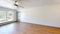 Located at 211 E Davis St in Dallas, TX, this single-story, 3-bedroom, 1-bathroom home offers a practical and well-appointed layout. Wood-look flooring runs throughout, creating a cohesive and easy-to-maintain interior. The living room is a comfortable gathering space featuring a ceiling fan with light fixture, a textured ceiling, and a large window that invites natural light and outdoor views. Each of the three bedrooms continues the wood-look flooring and includes ceiling fans, white walls, and generous closet space — with some bedrooms featuring dual bi-fold closet doors and a walk-in closet option for additional storage. The kitchen is a standout feature, offering a galley-style layout with white shaker cabinetry, brushed nickel hardware, gray subway tile backsplash, light countertops, a stainless steel sink, and stainless steel appliances including a gas range, over-the-range microwave, refrigerator, and dishwasher. The bathroom includes a full tub-shower combination with clean white tile surround. A connecting hallway links the rooms efficiently. Overall, the home presents a clean, updated aesthetic suitable for comfortable everyday living.