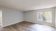 Located on Carlton Way in the heart of Hollywood, this two-bedroom, two-bathroom residence offers a well-designed single-floor layout that maximizes functionality and comfort. Throughout the home, wood-look flooring lends a warm, cohesive aesthetic that ties each room together seamlessly.

The living room is a welcoming, light-filled space featuring a classic fireplace and a large window dressed with vertical blinds that invite natural light. The kitchen stands out with crisp white shaker cabinetry, stone-look quartz countertops, a stainless steel double-basin sink, a dishwasher, and a striking mosaic tile backsplash in black, white, and gray tones that adds a modern accent.

Both bedrooms are comfortably sized with soft neutral wall tones, textured ceilings, and sliding glass doors that open to private balconies offering outdoor views of the surrounding neighborhood. The spacious primary bedroom also includes a dedicated closet. Each bathroom is clean and functional, featuring tub-shower combinations with white tile surrounds, vanities with stone-look countertops, and wood-look flooring. The hallway connects all rooms efficiently, and the entryway provides a tidy, welcoming arrival point with direct sightlines to the living and kitchen areas.