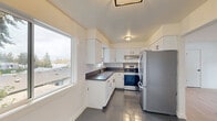 This newly renovated apartment in Tigard, Oregon offers 680 square feet of efficiently designed living space. The single-story layout includes two bedrooms, one bathroom, a kitchen, living room, and hallway. The primary bedroom boasts 140 square feet, providing ample space for a comfortable retreat.

Throughout the apartment, light wood flooring creates a warm and inviting atmosphere, complemented by crisp white walls that enhance the sense of space and brightness. Large windows in each room allow natural light to flood the interior, creating an airy ambiance.

The kitchen showcases a modern design with white cabinetry, dark countertops, and stainless steel appliances. Grey tile flooring in the kitchen adds a contemporary touch and contrasts nicely with the wood flooring in adjacent areas. The bathroom features a clean, white design with a combination tub-shower, modern fixtures, and continuation of the wood flooring.

The living area is spacious and versatile, perfect for various furniture arrangements. Sliding closet doors in the bedrooms provide ample storage without intruding on the floor space. The property's location at 11380 SW Greenburg Rd places residents in the heart of Tigard, offering convenient access to local amenities and transportation routes.