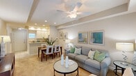 This well-appointed one-bedroom, one-bathroom residence in Metairie, Louisiana offers a thoughtfully designed single-level layout that maximizes functionality and comfort. The open-concept living and dining area is anchored by plush carpeting, a ceiling fan with light fixture, and a tray ceiling detail that adds architectural interest. Recessed lighting illuminates the space, while multiple windows dressed with grommet-panel drapes allow natural light to filter through.

The kitchen is efficiently designed with crisp white cabinetry, granite countertops, tile flooring, and a full suite of stainless steel appliances including a range, built-in microwave, refrigerator, and dishwasher. A peninsula counter connects the kitchen to the dining area, creating a seamless flow ideal for everyday living and entertaining.

The bedroom features a ceiling fan, carpeted floors, and a walk-in closet, providing ample storage. Neutral wall tones and natural light from a window contribute to a calm, restful atmosphere.

The bathroom is finished with a granite-topped vanity, white cabinetry with overhead storage, tile flooring, and a shower/tub combination, maintaining the consistent quality found throughout the residence.